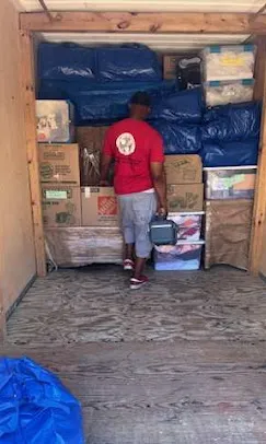 Diverse Moving Solutions team staging boxed living room items in Chandler